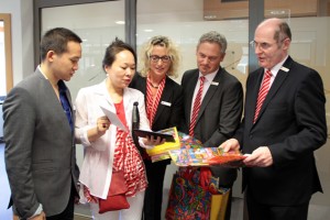 Leland Lee (v.l.) und seine Mutter Karen Chien Lee bedankten sich mit kleinen Geschenken bei den Mitarbeitern der Kreissparkasse Euskirchen - Rita Witt, Marc Eichholz und Helmut Habscheid - für die tolle Unterstützung in Zülpich. Bild: Michael Thalken/Eifeler Presse Agentur/epa