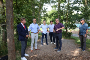 Bürgermeister Jan Reichelt (2.v.r.) erklärte die Baumaßnahmen am neuen Skaterpark und am Pumptrack und bedankte sich besonders bei Karl-Heinz Daniel (links) für die große Unterstützung durch die Kultur- und Sportstiftung, die sich bei der Skateranlage ins Zeug gelegt hatte. Bild: Michel Thalken/Eifeler Presse Agentur/epa
