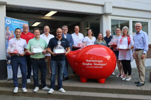 Ein vorläufig letztes Mal machte das rote „GiroCents“-Schwein jetzt im Kreis Euskirchen Halt, diesmal bei der Lebenshilfe Kreisvereinigung Euskirchen. Der Vorstandsvorsitzende der KSK, Holger Glück (r.), konnte erneut gut 11.000 Euro an Zuwendungen an ehrenamtliche Initiativen und Vereine im Kreis Euskirchen überreichen. Bild: Michael Thalken/Eifeler Presse Agentur/epa